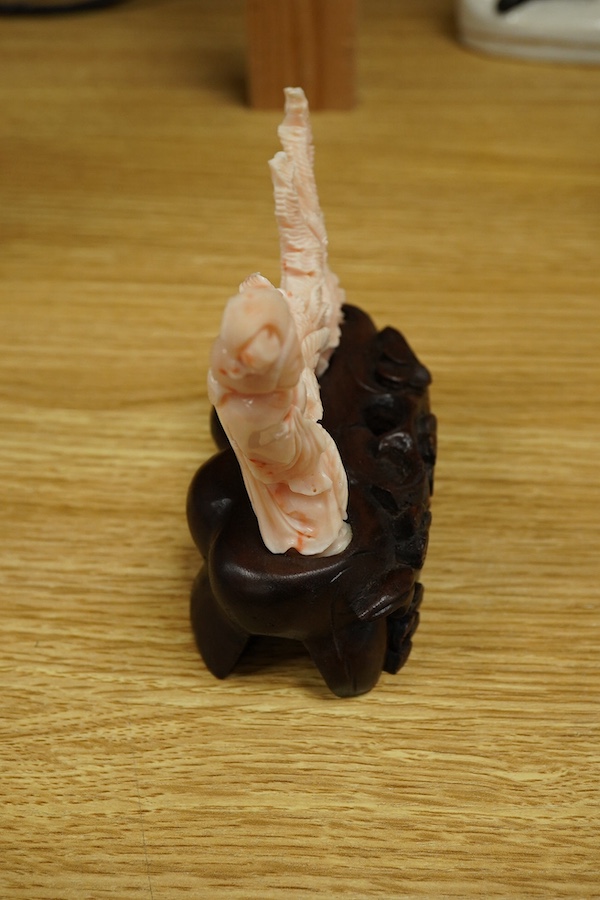 A Chinese coral group of a lady and a phoenix on carved hardwood base, 11cm high. Condition - good